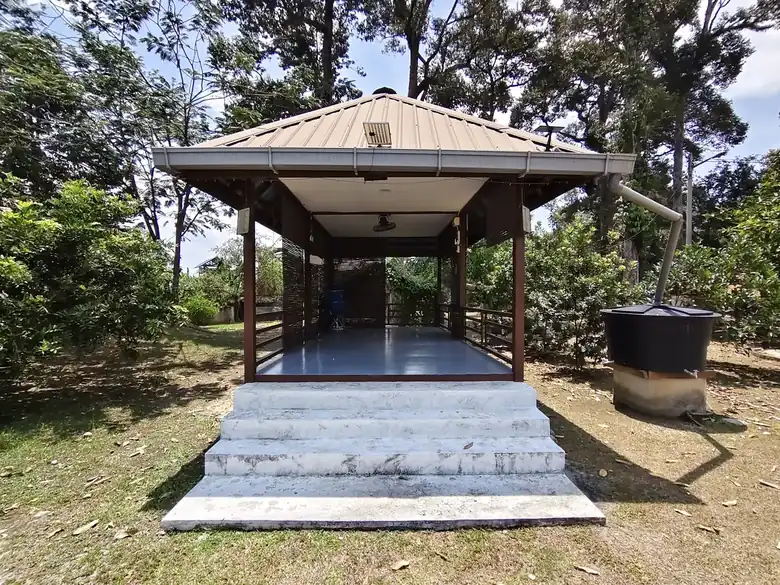 The open surau reached by concrete steps under trees